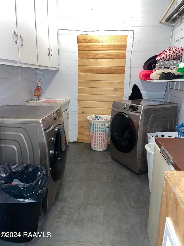 laundry area featuring sink, washer and dryer, and cabinets