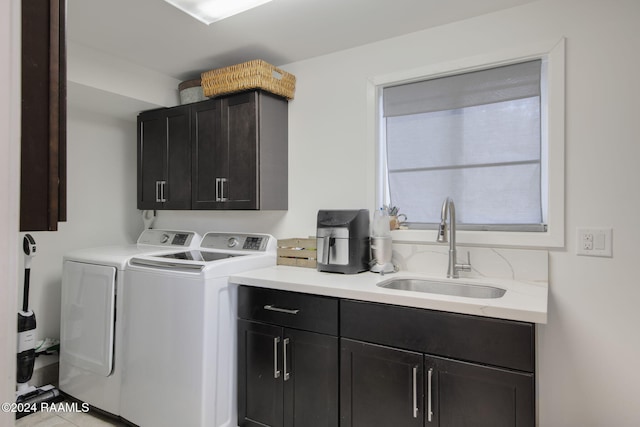 washroom with independent washer and dryer, sink, and cabinets