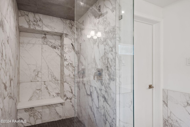full bath with a marble finish shower