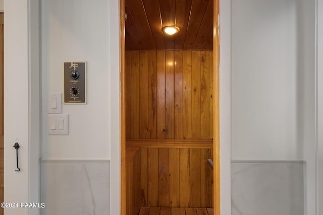 interior details featuring wood walls and wood ceiling