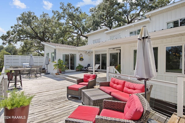 wooden terrace with an outdoor hangout area