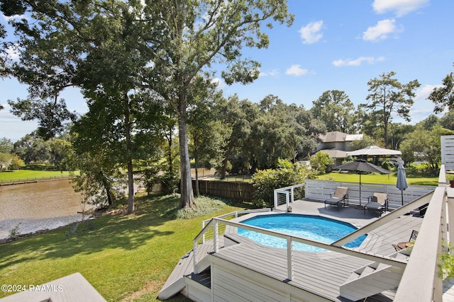view of swimming pool with fence, a lawn, and a fenced in pool