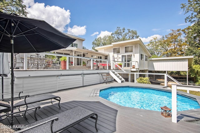 pool with stairway and a deck