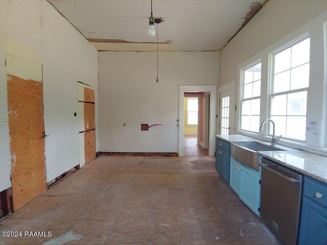 kitchen with sink, blue cabinetry, and stainless steel dishwasher