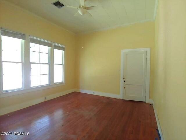 spare room with ceiling fan, ornamental molding, and dark wood-type flooring