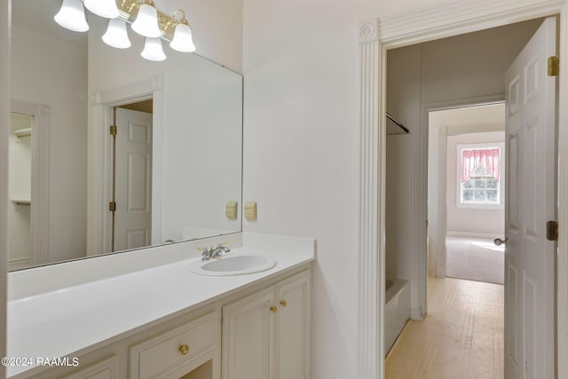 bathroom with tub / shower combination, vanity, and hardwood / wood-style flooring