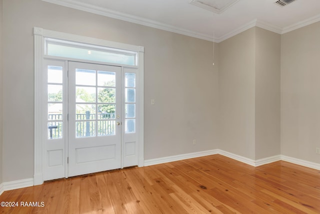 doorway to outside featuring wood-type flooring and crown molding