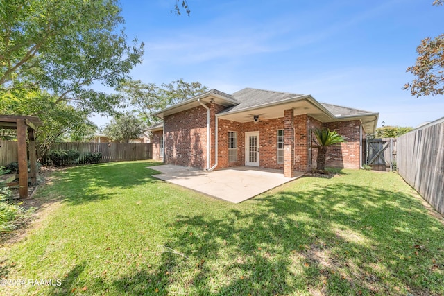 back of house with a yard, ceiling fan, and a patio area