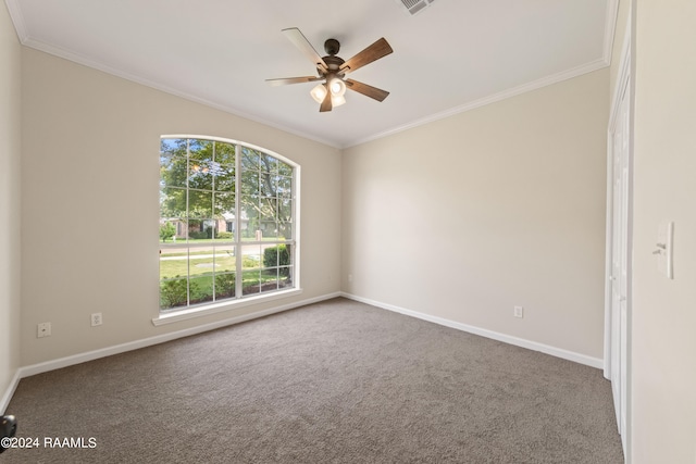 spare room featuring carpet, ceiling fan, and crown molding