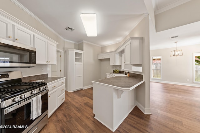 kitchen featuring kitchen peninsula, white cabinetry, dark wood-type flooring, and stainless steel appliances