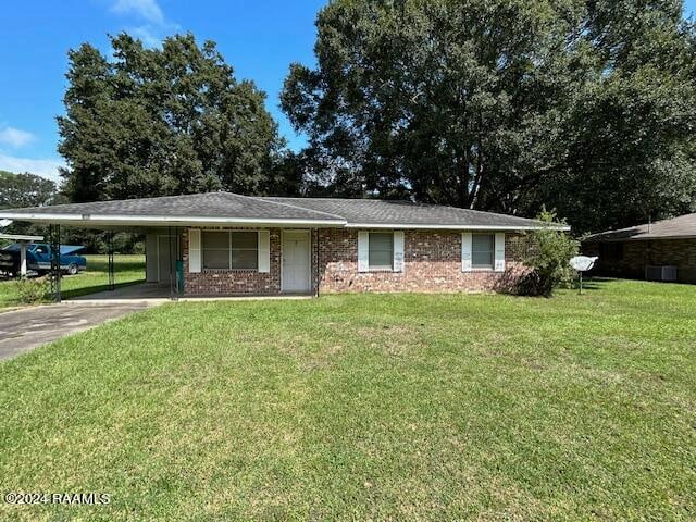 ranch-style home with a front lawn and a carport