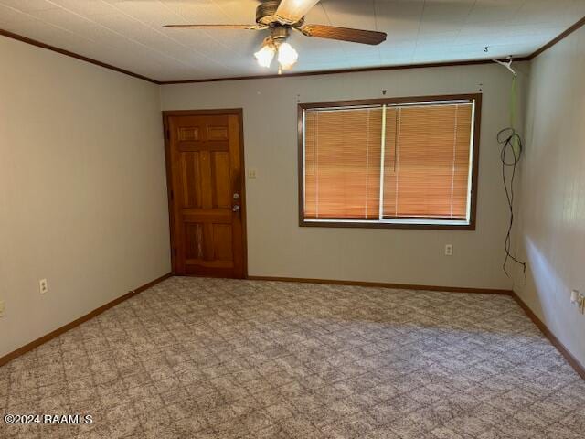 carpeted empty room featuring crown molding and ceiling fan