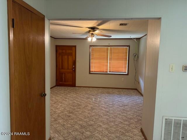 empty room featuring ceiling fan and carpet flooring