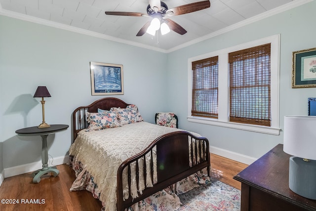 bedroom featuring wood-type flooring, crown molding, and ceiling fan