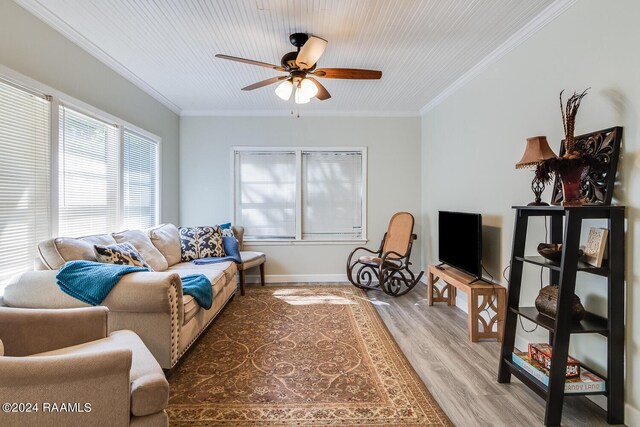 living room with wood-type flooring, ceiling fan, and crown molding