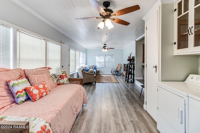 bedroom featuring crown molding, separate washer and dryer, ceiling fan, and light hardwood / wood-style flooring