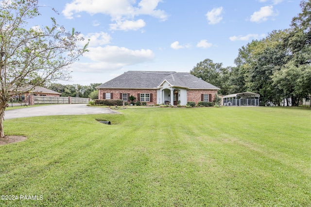 view of front facade with a carport and a front yard