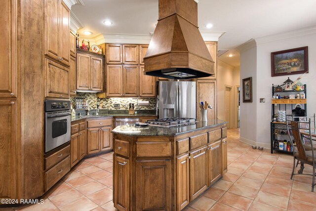 110 River Wood Pl, Abbeville, LA 70510 - kitchen with stainless steel appliances, custom range hood, a sink, tasteful backsplash, and light tile patterned flooring