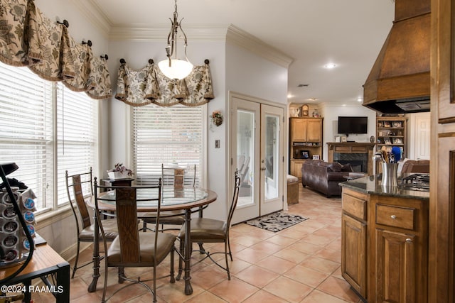 110 River Wood Pl, Abbeville, LA 70510 - dining space with a premium fireplace, crown molding, light tile patterned flooring, and french doors