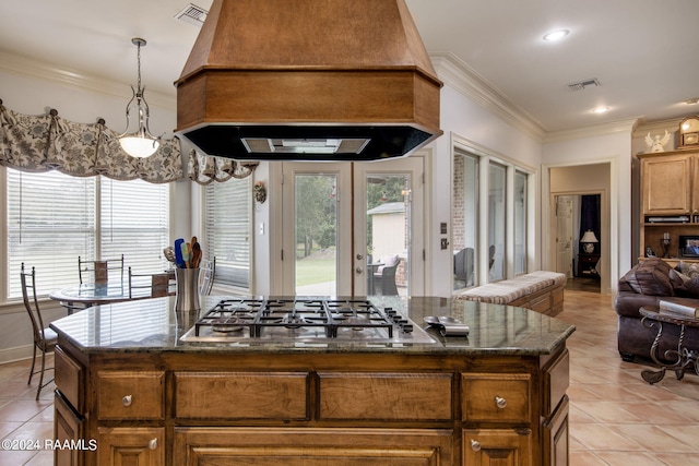110 River Wood Pl, Abbeville, LA 70510 - kitchen with custom exhaust hood, stainless steel gas cooktop, light tile patterned flooring, french doors, and ornamental molding