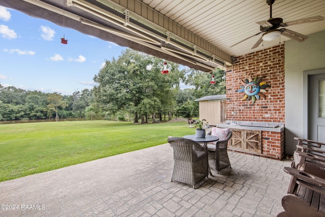 110 River Wood Pl, Abbeville, LA 70510 - view of patio featuring a ceiling fan and view of scattered trees