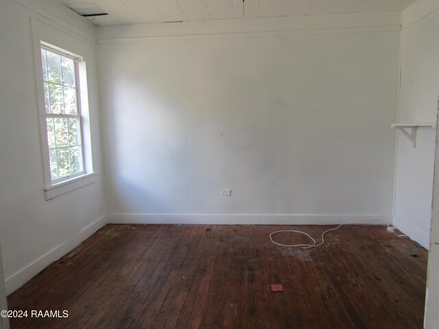 unfurnished room with dark hardwood / wood-style flooring