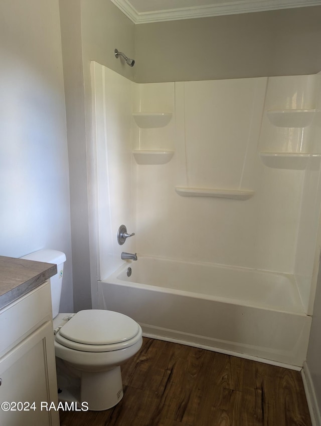 full bathroom featuring wood-type flooring, tub / shower combination, crown molding, vanity, and toilet