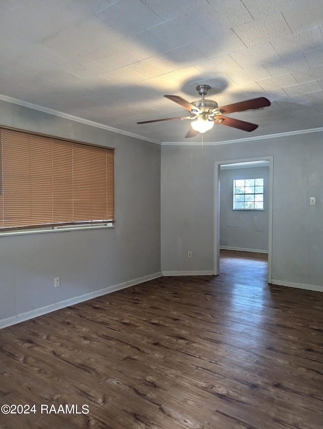 empty room featuring ornamental molding, dark hardwood / wood-style floors, and ceiling fan