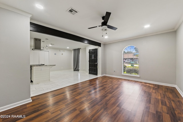 unfurnished living room featuring ceiling fan, a fireplace, hardwood / wood-style floors, and crown molding