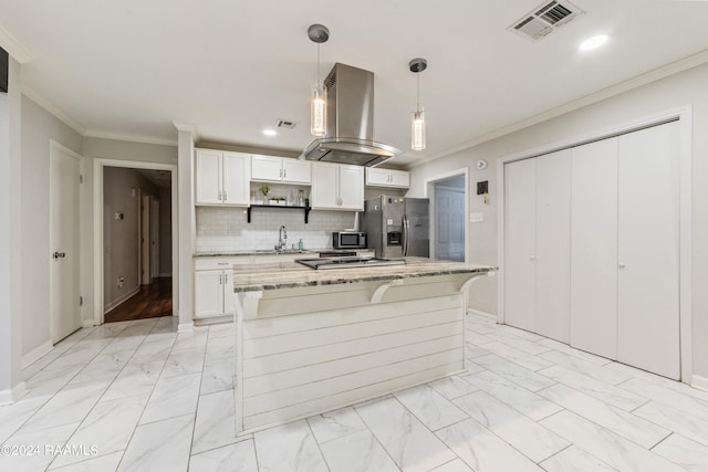 kitchen featuring hanging light fixtures, a kitchen island, island exhaust hood, white cabinetry, and stainless steel appliances