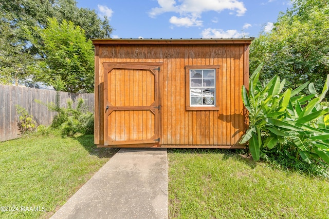 view of outbuilding with a yard