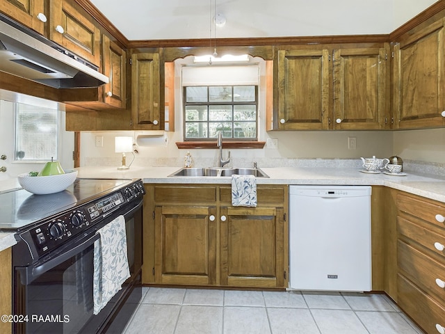 kitchen featuring dishwasher, electric range, light tile patterned floors, and sink