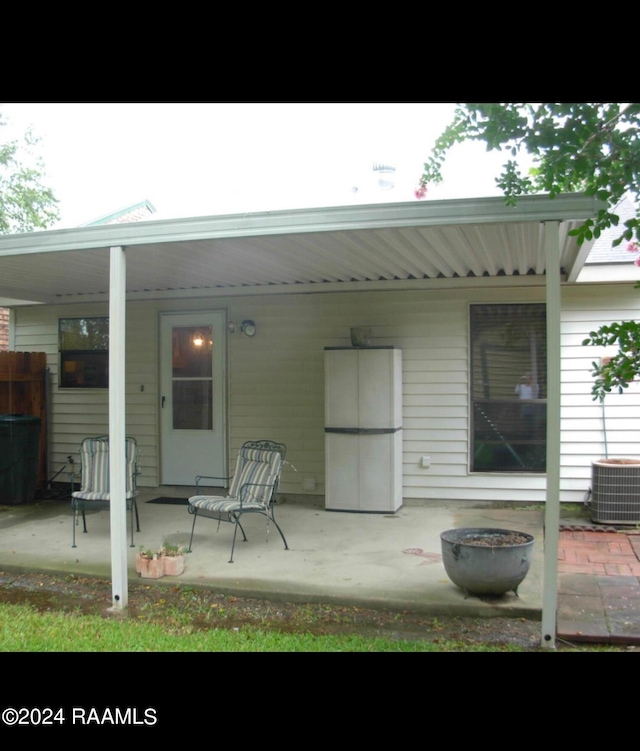 back of house with central AC unit and a patio area