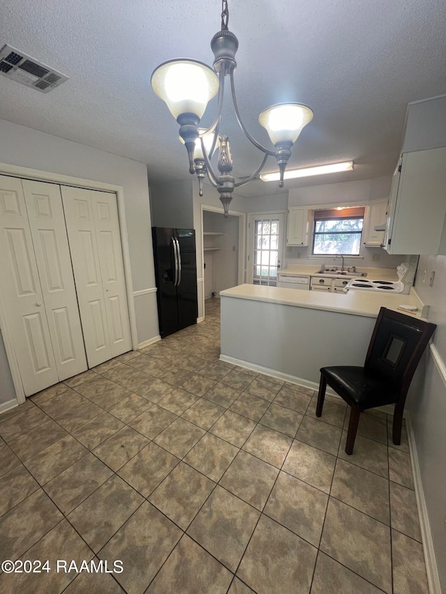 kitchen with hanging light fixtures, white cabinetry, black fridge with ice dispenser, kitchen peninsula, and a chandelier