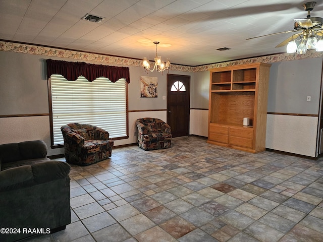 living room with ceiling fan with notable chandelier