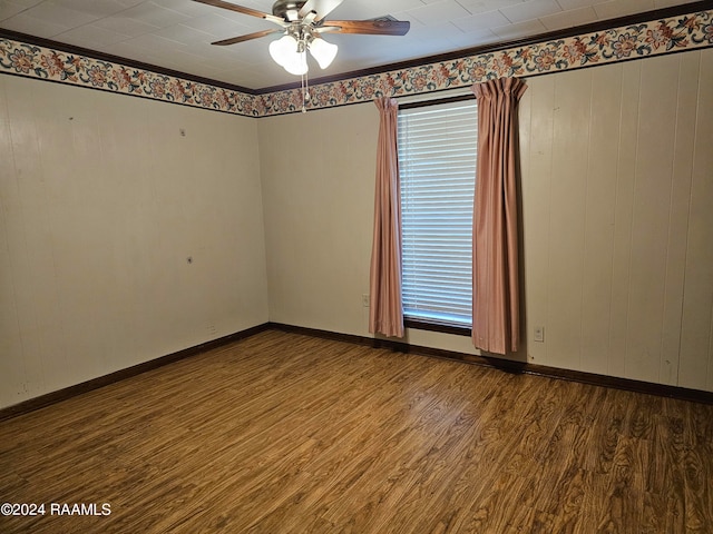 unfurnished room with hardwood / wood-style floors, ceiling fan, a healthy amount of sunlight, and crown molding