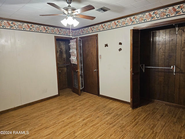 unfurnished bedroom featuring hardwood / wood-style flooring, ceiling fan, and ornamental molding