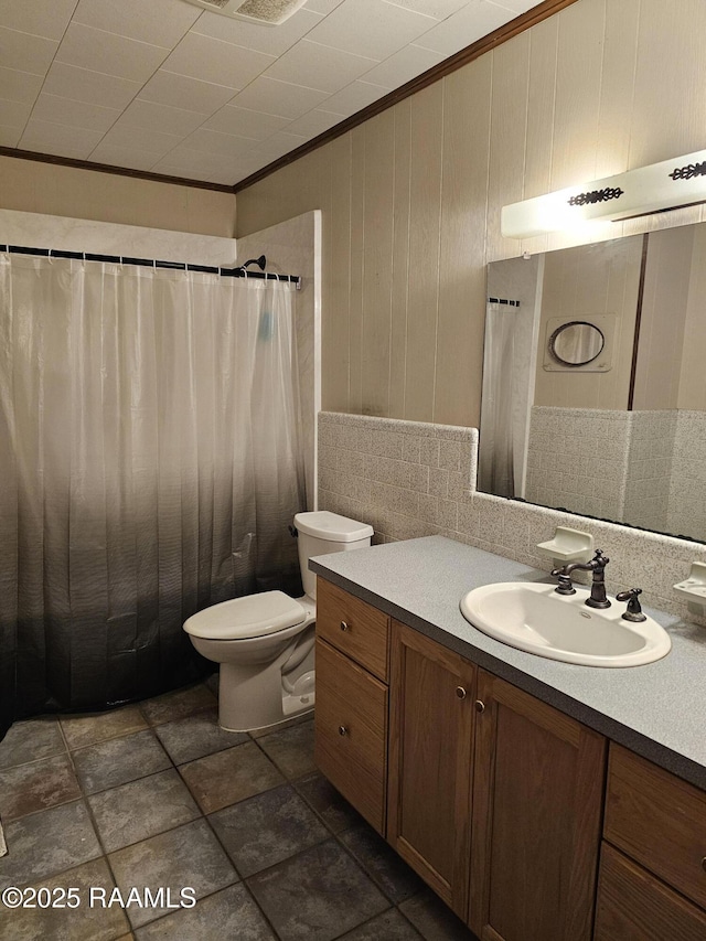 bathroom featuring vanity, toilet, and ornamental molding