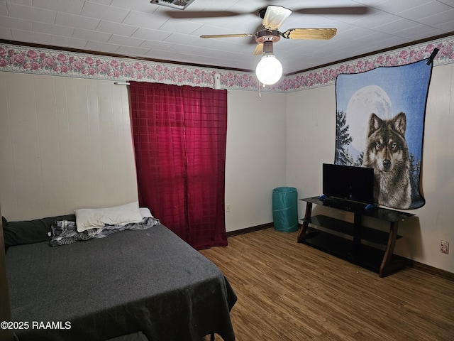 bedroom featuring wood-type flooring and ceiling fan