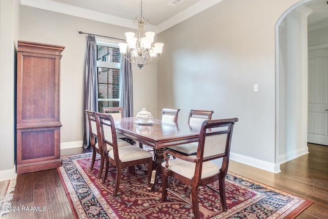 dining room with dark hardwood / wood-style floors, ornamental molding, and a chandelier