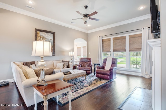 living room with ceiling fan, ornamental molding, and dark hardwood / wood-style flooring