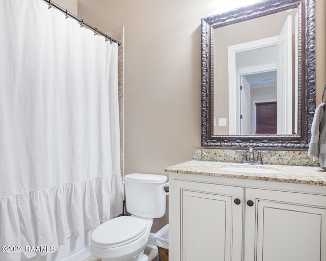 bathroom featuring walk in shower, vanity, and toilet