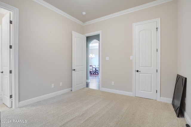 unfurnished bedroom featuring light colored carpet and ornamental molding