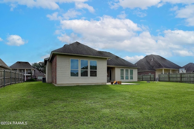 rear view of house with a yard