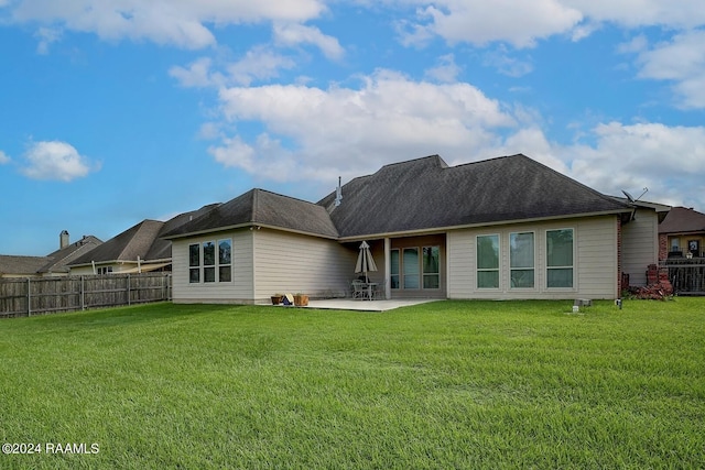 back of property with a yard, central AC unit, and a patio area