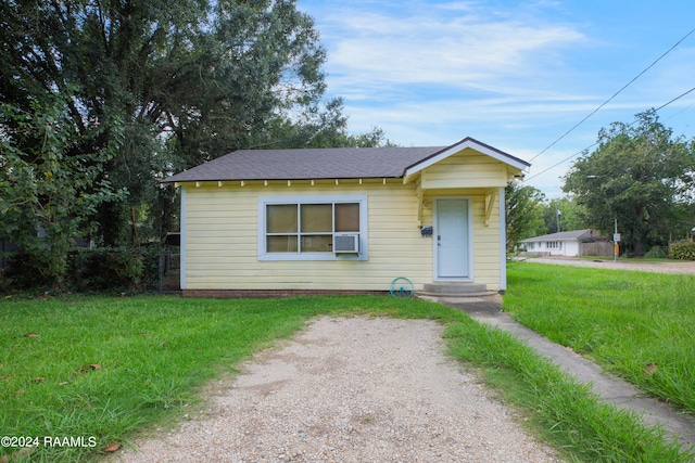 bungalow-style home with a front lawn