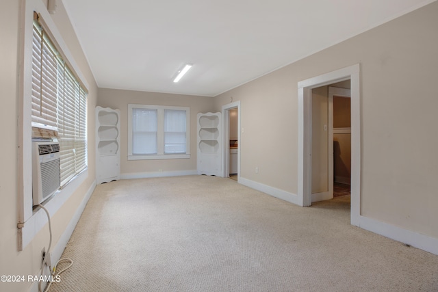 carpeted empty room featuring built in shelves