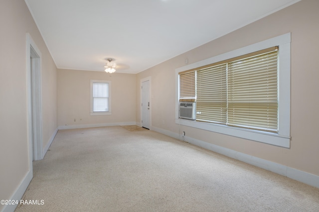 empty room featuring light carpet and cooling unit