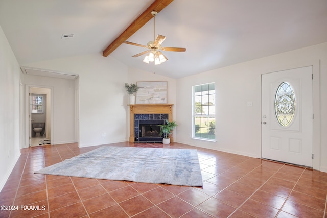 interior space featuring vaulted ceiling with beams, ceiling fan, and a fireplace