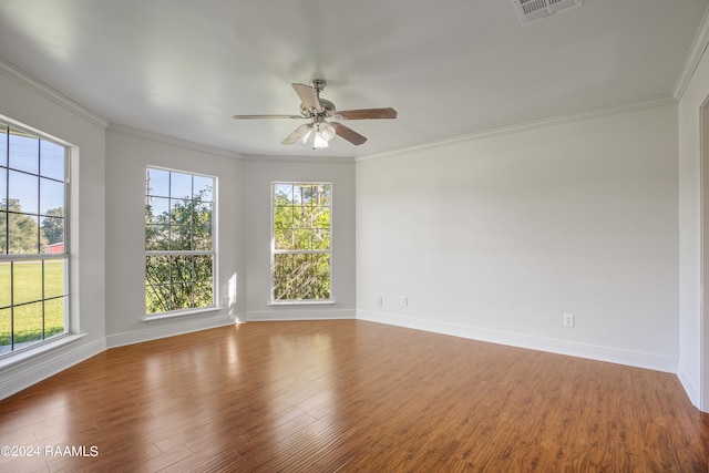 empty room featuring ornamental molding, ceiling fan, and hardwood / wood-style flooring